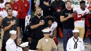 Quarterback Colin Kapernick kneels during the national anthem next to former Green Beret Nate Boyer, (CAP photo)