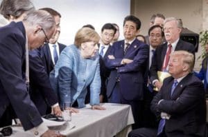 German Prime Minister Angela Merkel explains it all to Mr. Trump.
